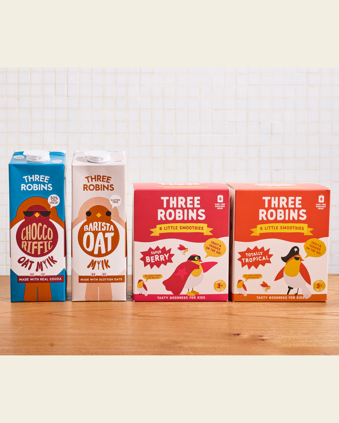 Three Robins Choccoriffic and Barista oat milk cartons beside multipack boxes of Super Berry Little Smoothies and Totally Tropical Little Smoothies